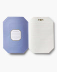 Octagonal notebook with a blue cover and white interior on a white background