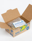 Open cardboard box with plastic bags and an invoice on a white background