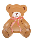 Teddy bear-shaped plate with a red bow on a white background