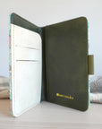 Inside view of the passport cover with two slots on one side and a logo of the bottom right side.