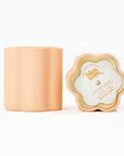 peach container of a candle's side view and top view. Top view has paper cover of scent and text