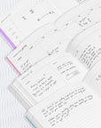 Open planner with handwritten notes on a textured white surface