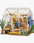 A miniature DIY dollhouse with a garden house theme, featuring various furniture, potted plants, and gardening tools.