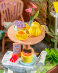 Miniature tea set on a table with a colorful background
