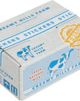 Box of Creamy Hills Farm stickers with cow illustrations and 'Fresh' label.