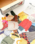 A collection of colorful miniature fabric accessories and clothing piece stickers on white background