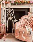 Decorative skeletons in a living room with Halloween decorations.