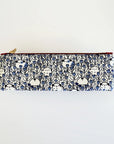 A multicolored coin purse with a brass zipper and a metal key ring, featuring a pattern of guinea pigs, flowers, and leaves with a white background