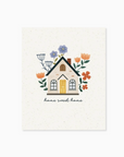 A greeting card with a pop-up design featuring a house, surrounded by floral elements and the text 'home sweet home'.