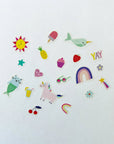 A variety of rainbow themed stickers on a white background