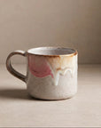 Ceramic mug with abstract design on a beige background