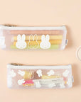 Transparent pencil case with rabbit designs on a beige background