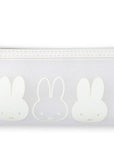 White pouch with rabbit designs on a white background