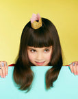 Child wearing a gold glitter crown on her head
