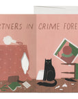 inside of a greeting card with cats in a messy room and text reading "partners in crime forever"