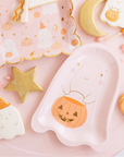 pink halloween tablescape with cookies and pink halloween plates