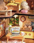 Detailed puppy themed dollhouse interior with furniture, decor, and a laptop displaying a cartoon dog.