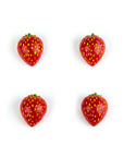 Four small strawberry-shaped items arranged in a 2x2 grid on a plain white background.