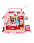 A pink and red miniature toy milk carton shop set with a milk carton-shaped roof, detailed interior shelves, a counter, and small accessories, shown on a plain white background.