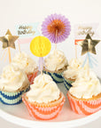 Cupcakes with decorative toppers and birthday cards on a white plate