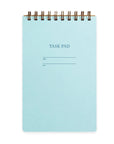 A blue notebook with a wire-o binding and a task pad design with lines and checkboxes on the interior pages.