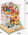 A DIY miniature dollhouse kitchen kit, with a variety of small toy kitchen items and a wooden base, designed for assembly.