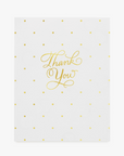 a greeting card with gold foil text "thank you" and confetti dots