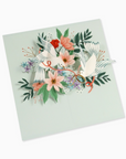 A pop-up design featuring a pair of white doves tied together with golden hoops, surrounded by floral elements