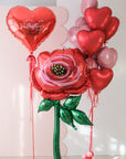 Valentine's Day-themed balloon bouquet trio with heart-shaped balloons, a large heart balloon, and a large flower balloon.