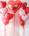 A closer look at the heart-shaped balloon bouquets with a 'Happy Valentine's Day' red heart balloon on a light background