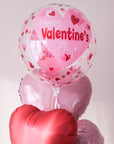 Clear bubble balloon with playful hearts