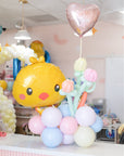 easter bunny balloon arrangement with balloon tulips sitting on a table counter in a store setting