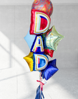 A bundle of Father's Day balloons with the word 'DAD' prominently displayed, featuring a variety of colors and decorations including stars and tassels.