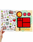 Sticker book of food themed items like sushi, noodles and dumplings next to a page of empty food containter box.