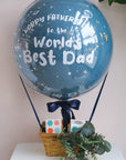 A Father's Day themed hot air balloon cupcake basket with decorative elements and a message.