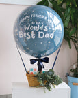 A Father's Day themed hot air balloon cupcake basket with decorative elements and a message.