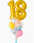 A balloon bouquet featuring a large gold number 18 balloon, with smaller multicolored balloons including pink, blue, and yellow, all adorned with confetti patterns. The balloons are attached to a ribbon bow and tassel.