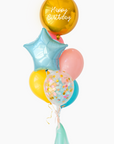 Colorful birthday balloons including a gold 'Happy Birthday' balloon on a white background