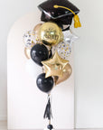 custom graduation balloons with grad cap shape in front of arch backdrop