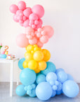 rainbow balloon garland on a stand