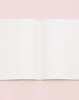 Lined white paper in an open notebook