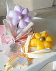 lavender and goldenrod balloon daises on a coffee table with books
