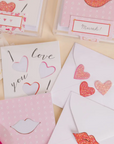 Small square card with glitter heart stickeres and white envelope