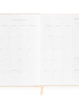 White calendar layout and peach tab on a white background
