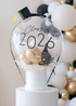 clear balloon with mini balloons inside on top of a white box, with graduation cap and "class of 2026" text 