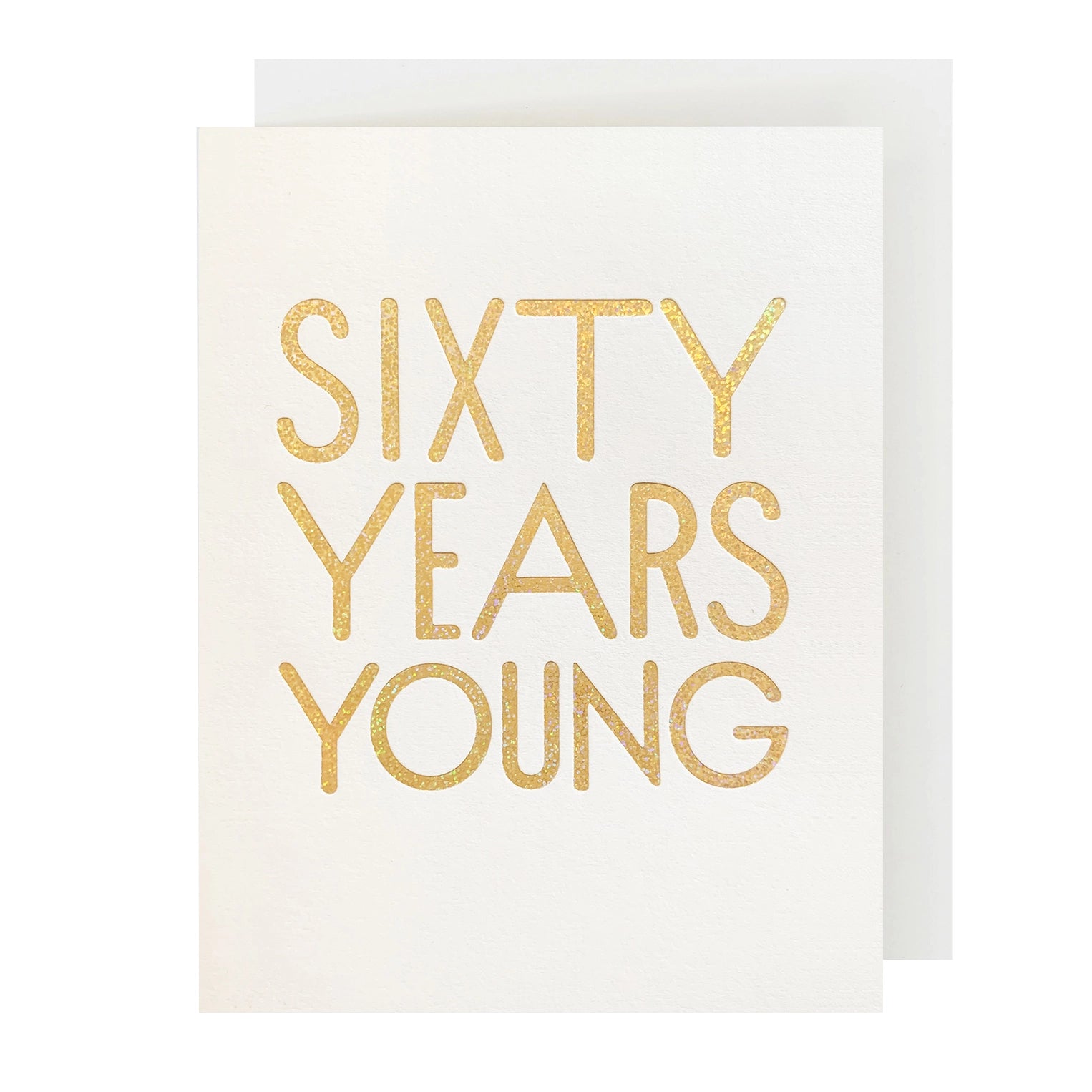 A white birthday card with 'SIXTY YEARS YOUNG' embossed in gold on the front, accompanied by a matching envelope.