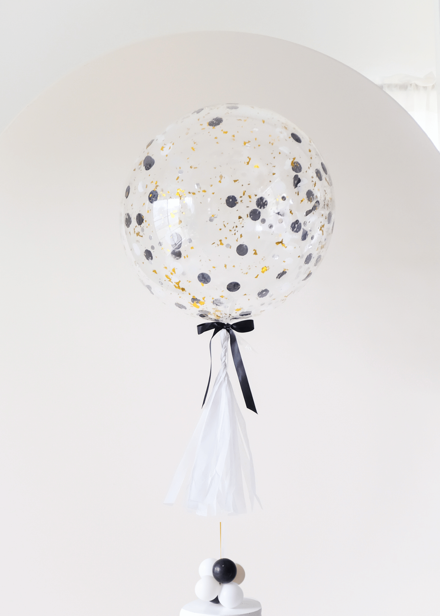 round confetti filled balloon with tassel and balloon weight