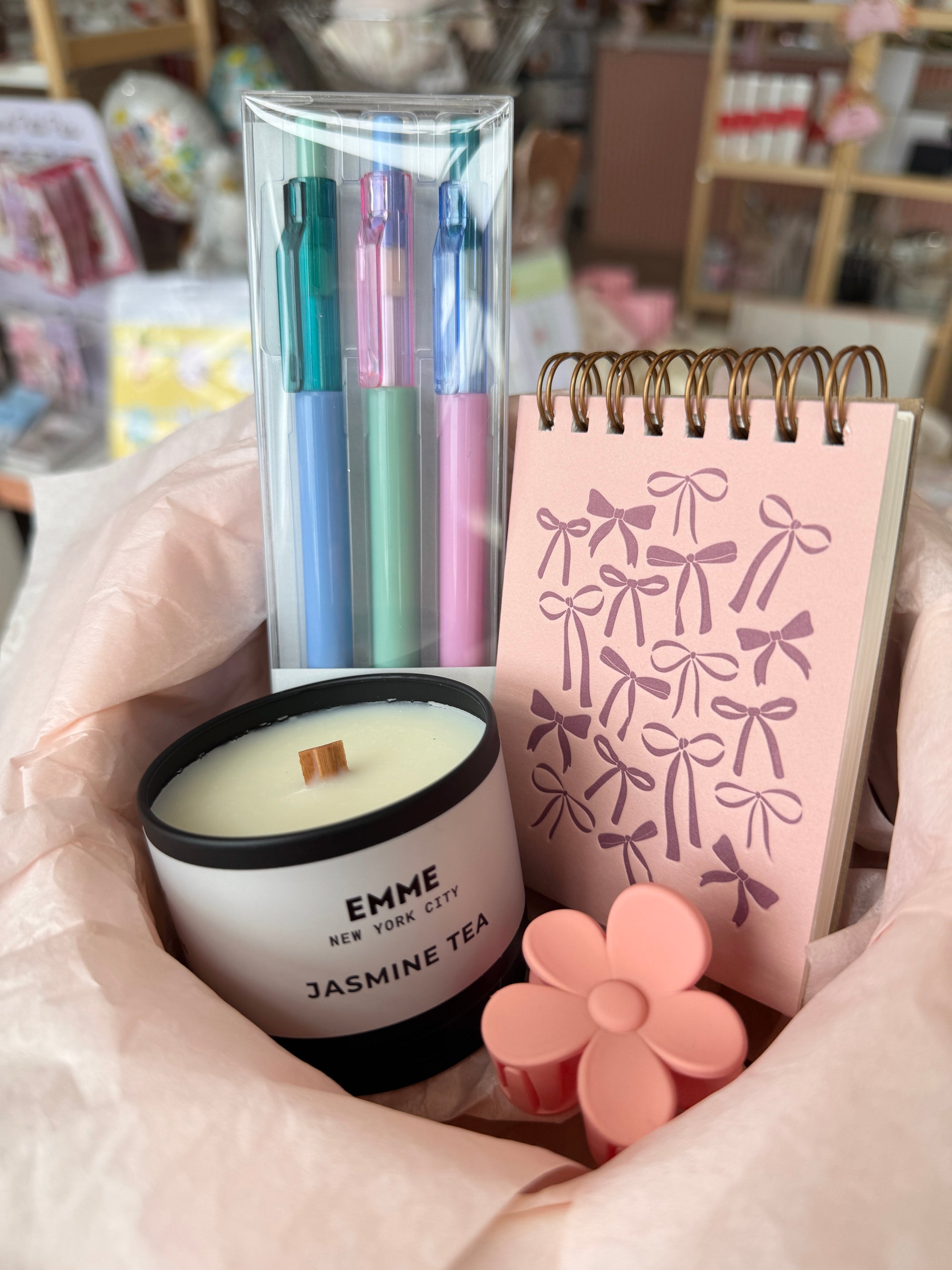 Pens, jasmine candle, hair clip, and notebook with bows
