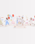 Card with illustrations of small animal characters celebrating a birthday with balloons and cake on a white background
