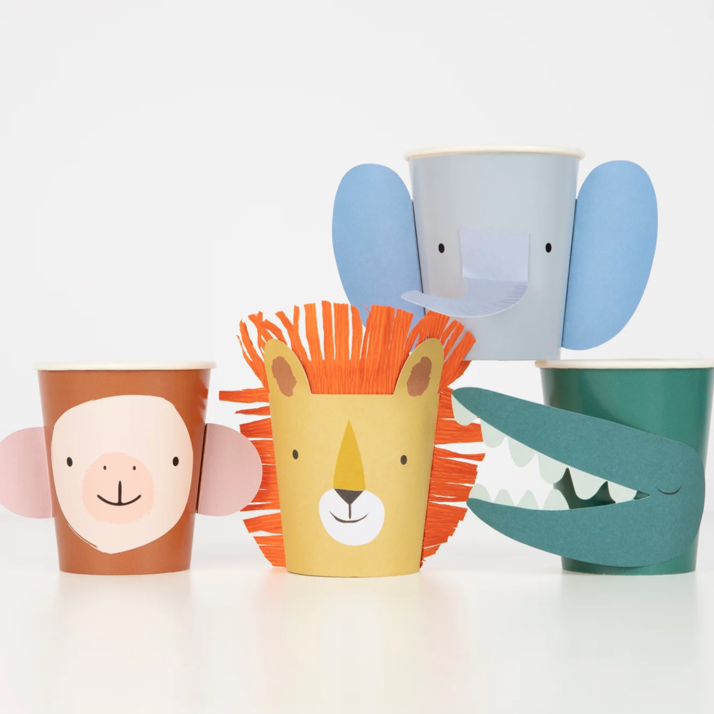 A set of animal-themed party cups in various designs, including a monkey, a lion, a giraffe, and a crocodile, against a white background.
